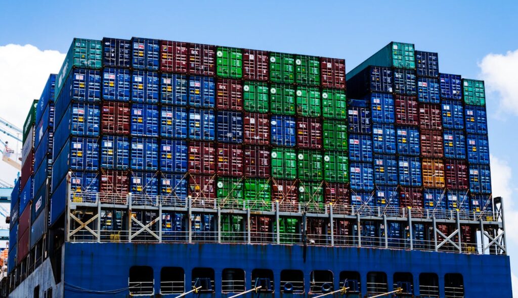 Stacked cargo containers on a massive ship at the harbor, symbolizing global trade.